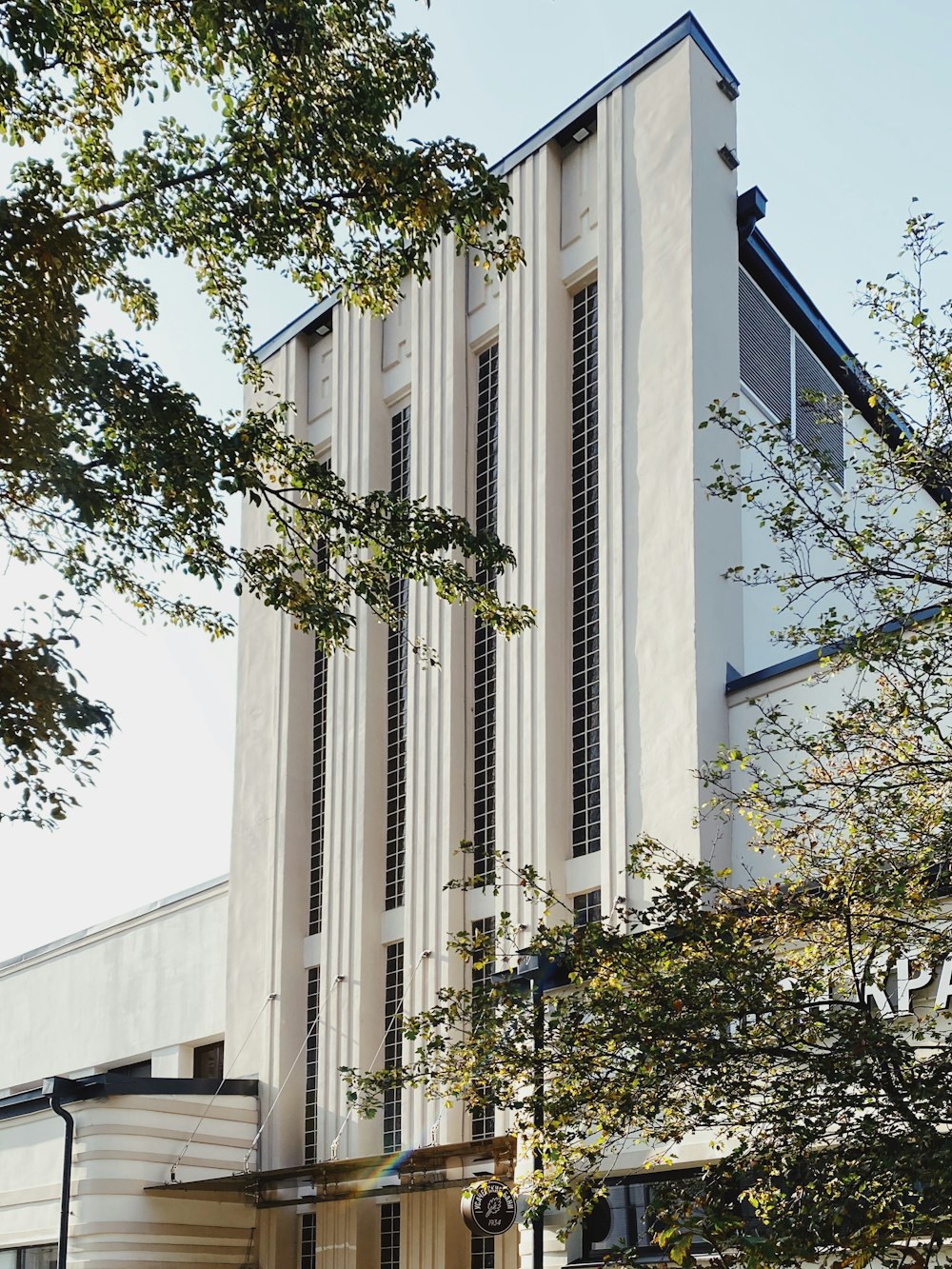 white concrete building near green trees during daytime