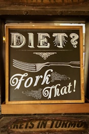 Sign reading ‘Diet? Fork that,’ symbolizing frustration with traditional diets