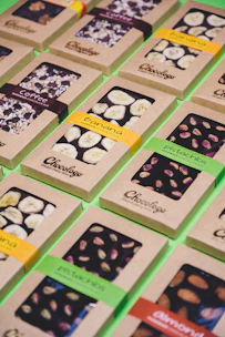 Handcrafted chocolate bars wrapped in eco-friendly packaging with cacao beans nearby.