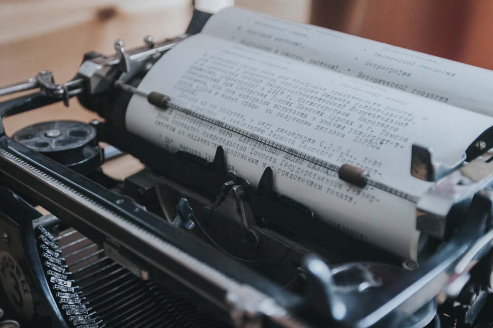 Old black typewriter with paper