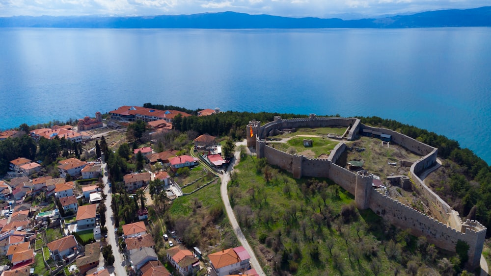 aerial view of houses near body of water during daytime