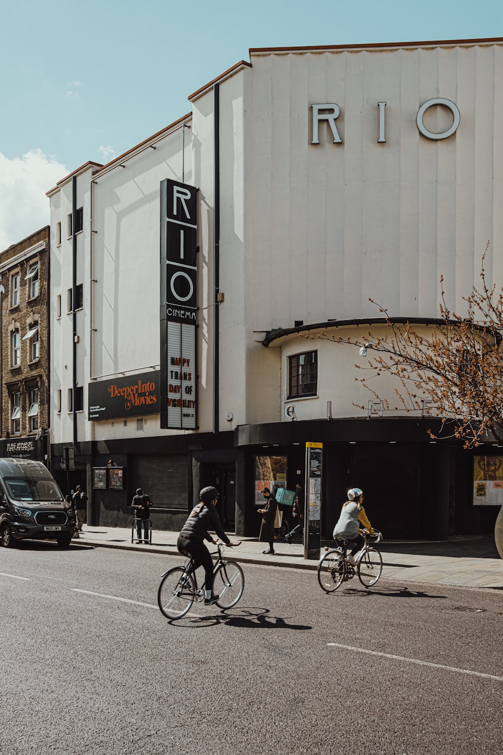 man in black jacket riding bicycle on road during daytime