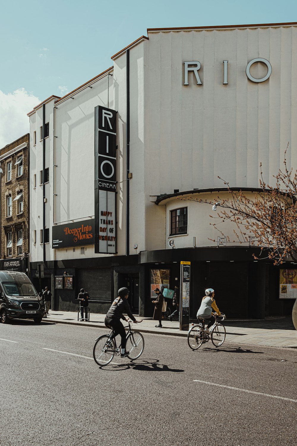 man in black jacket riding bicycle on road during daytime