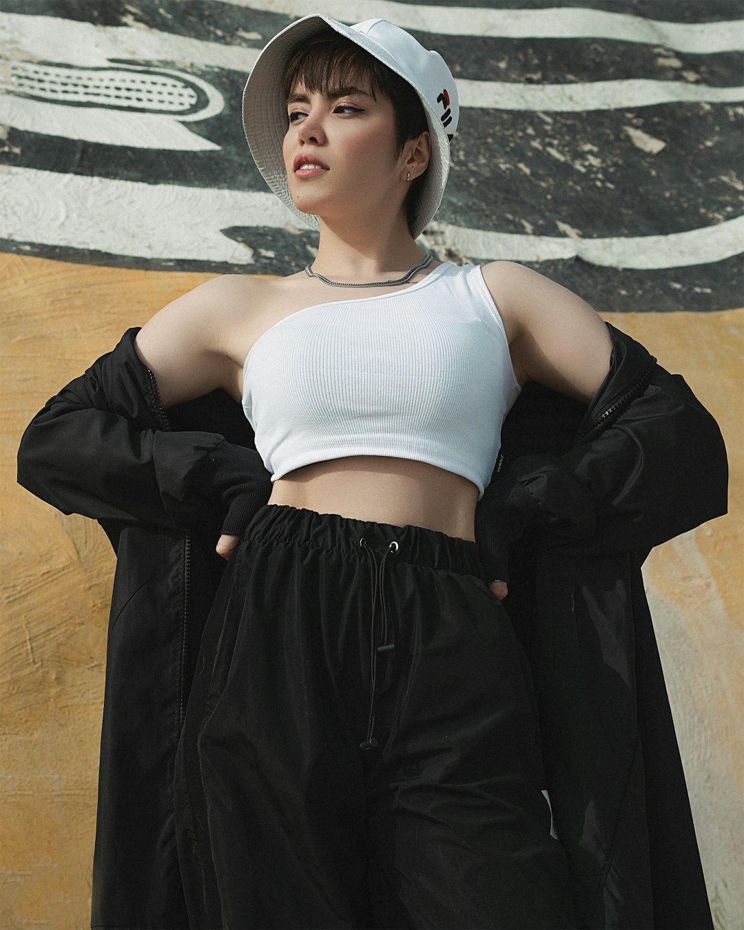 woman in white sports bra and black skirt