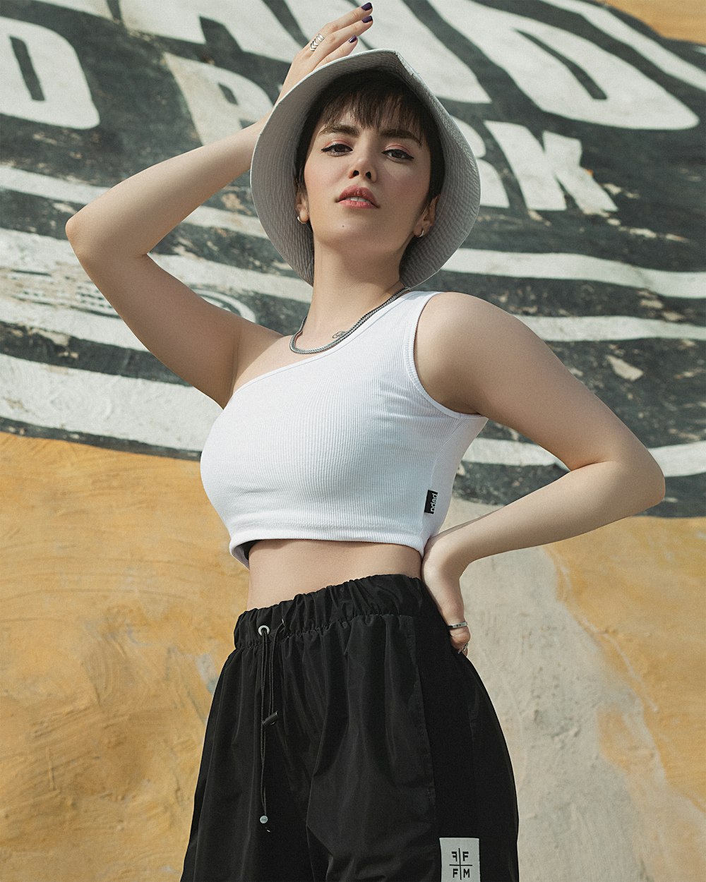 woman in white tank top and black skirt