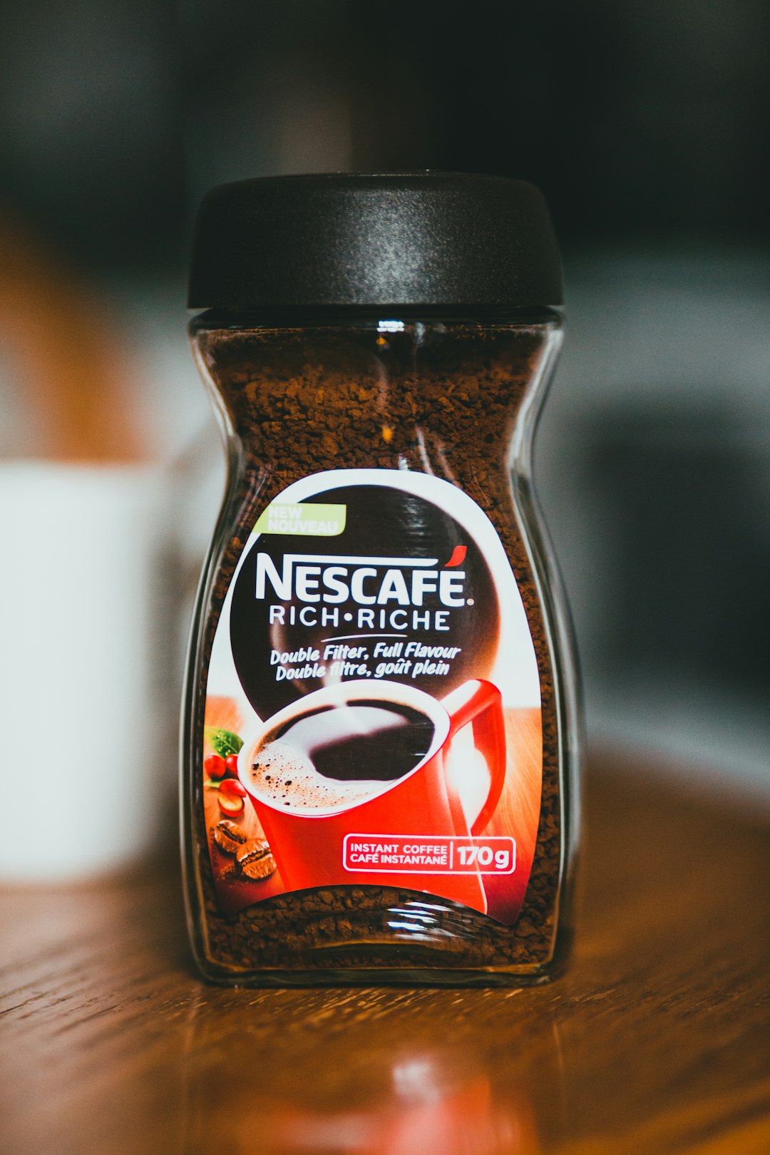 nescafe original coffee bottle on white table