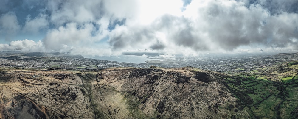 brown and green mountain under white clouds during daytime