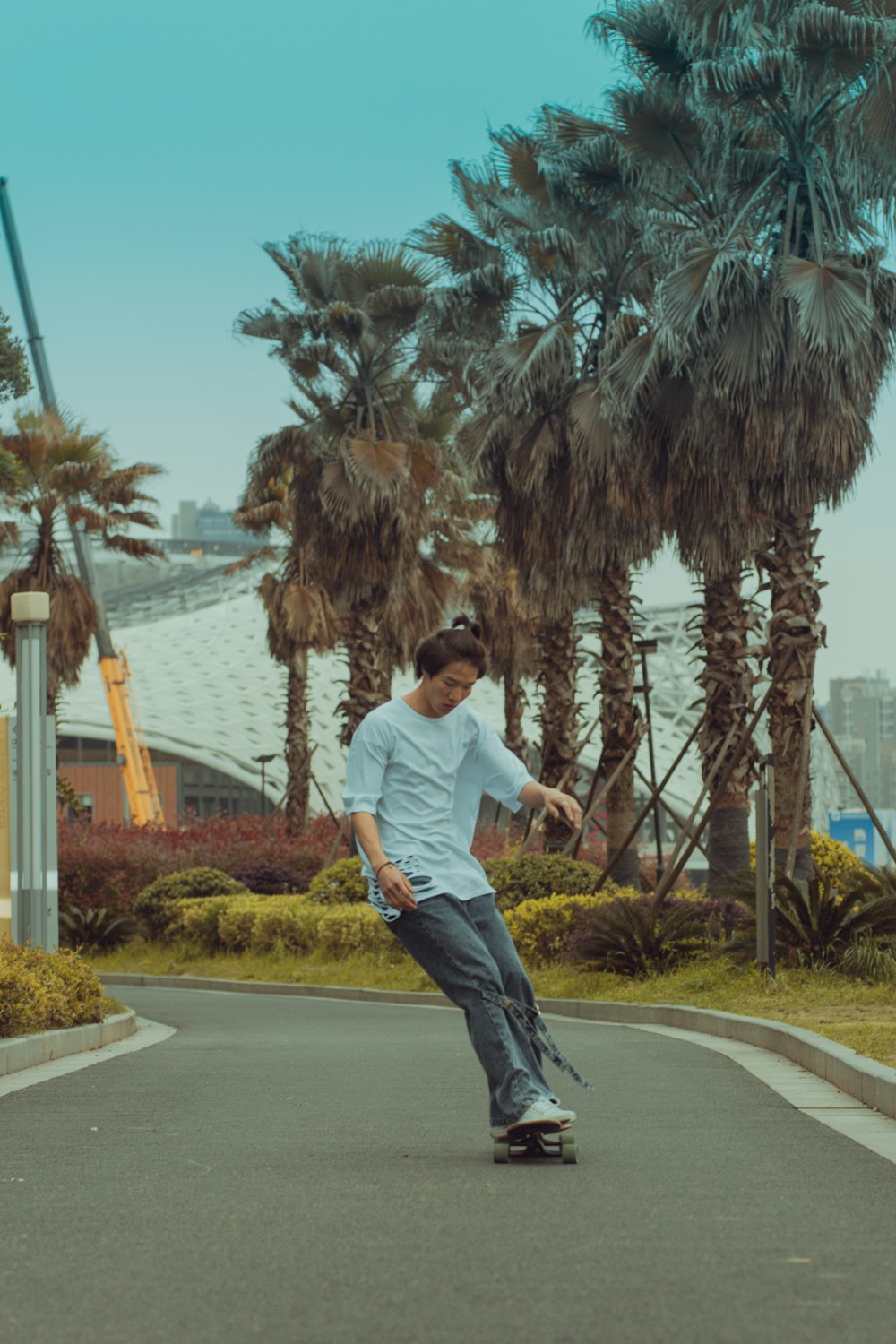 man in white t-shirt and black pants running on road during daytime