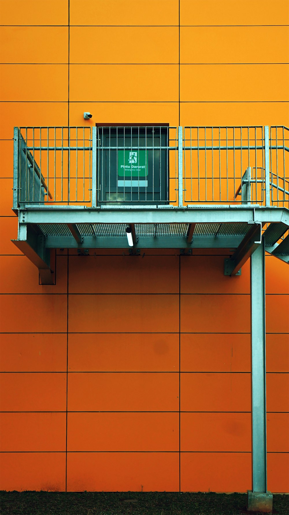 brown concrete building with green window