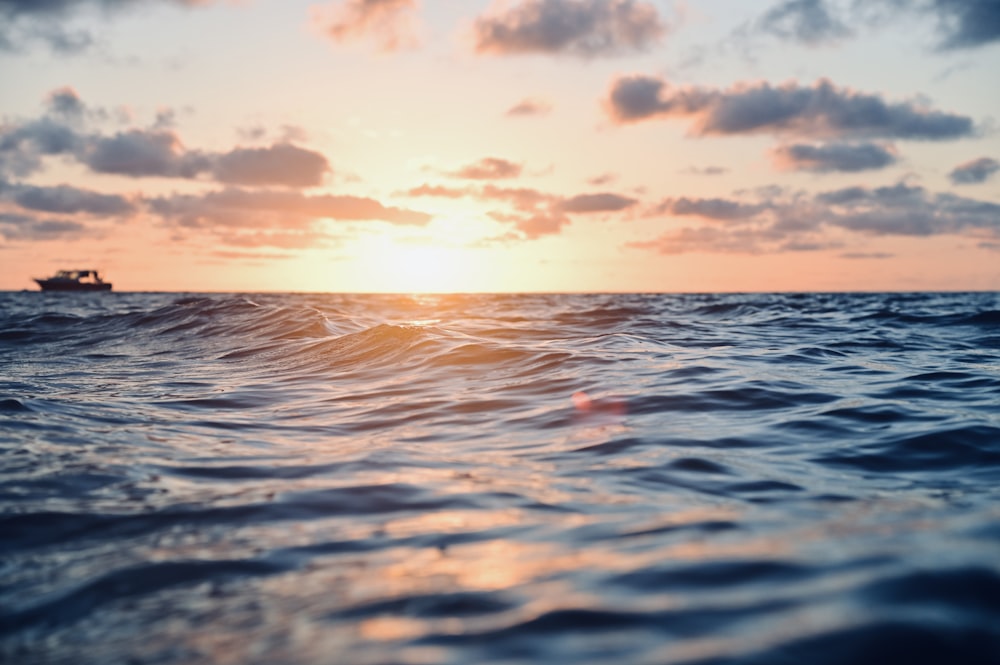 body of water under cloudy sky during daytime