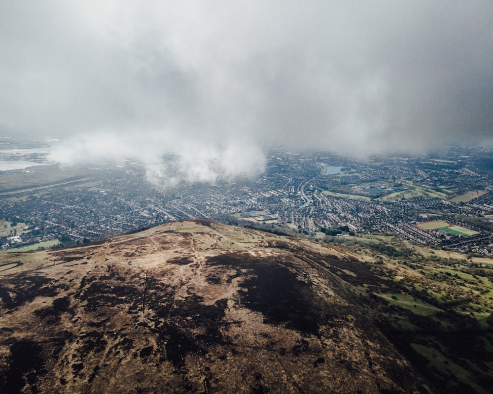 brown and white mountain under white clouds during daytime