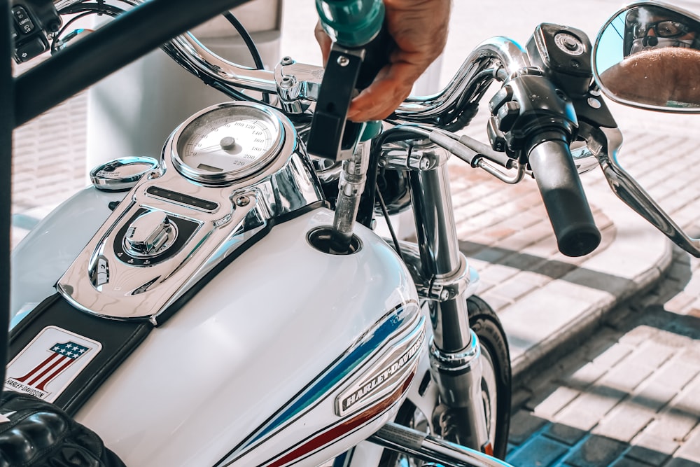 person riding on white and blue motorcycle