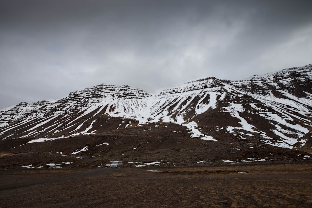 snow covered mountain under cloudy sky during daytime