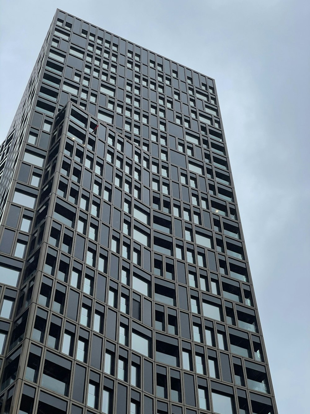 gray concrete building under white clouds during daytime