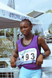 Athlete proudly wearing the event kit with a race bib and hydration pack.