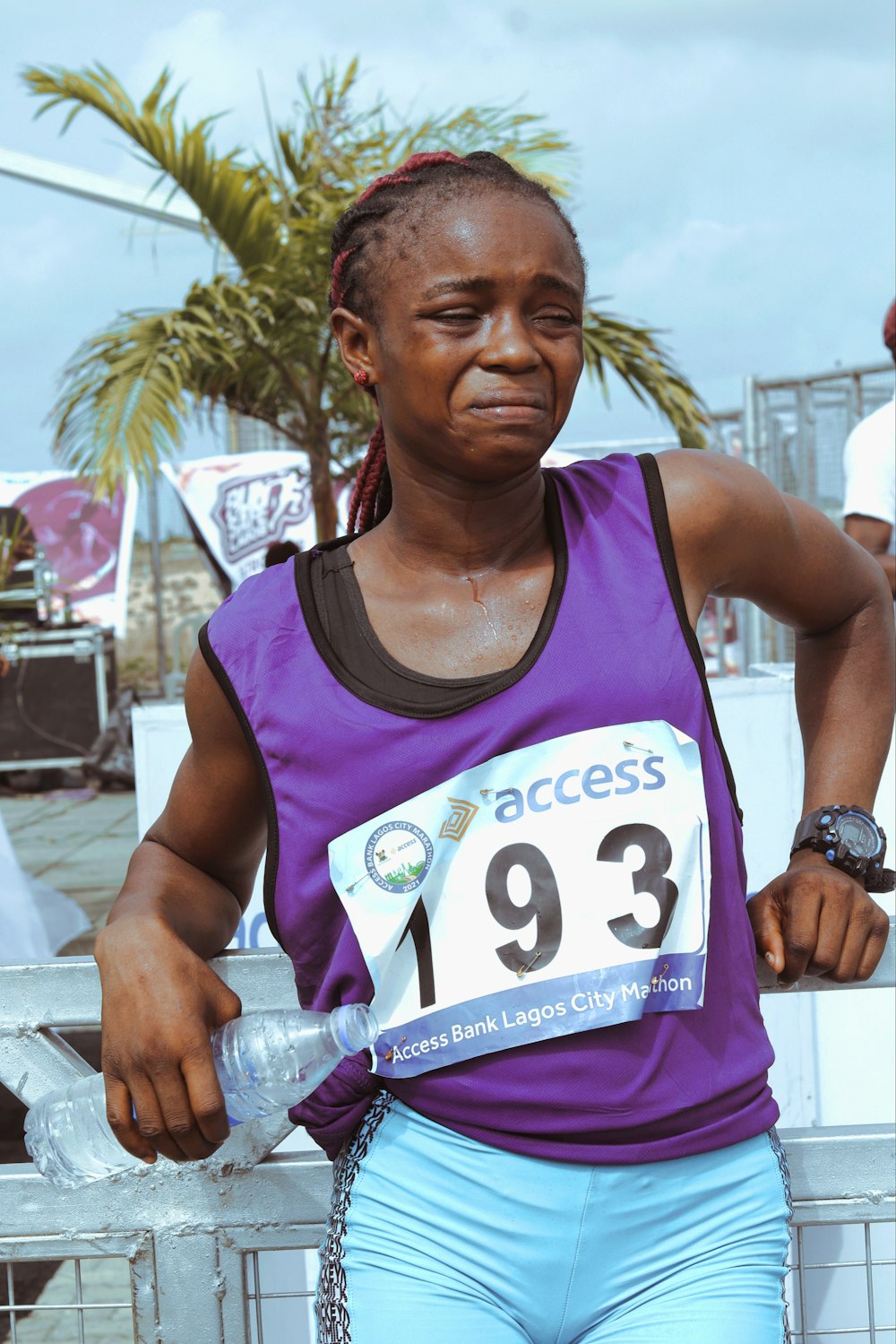 man in purple tank top holding his hands