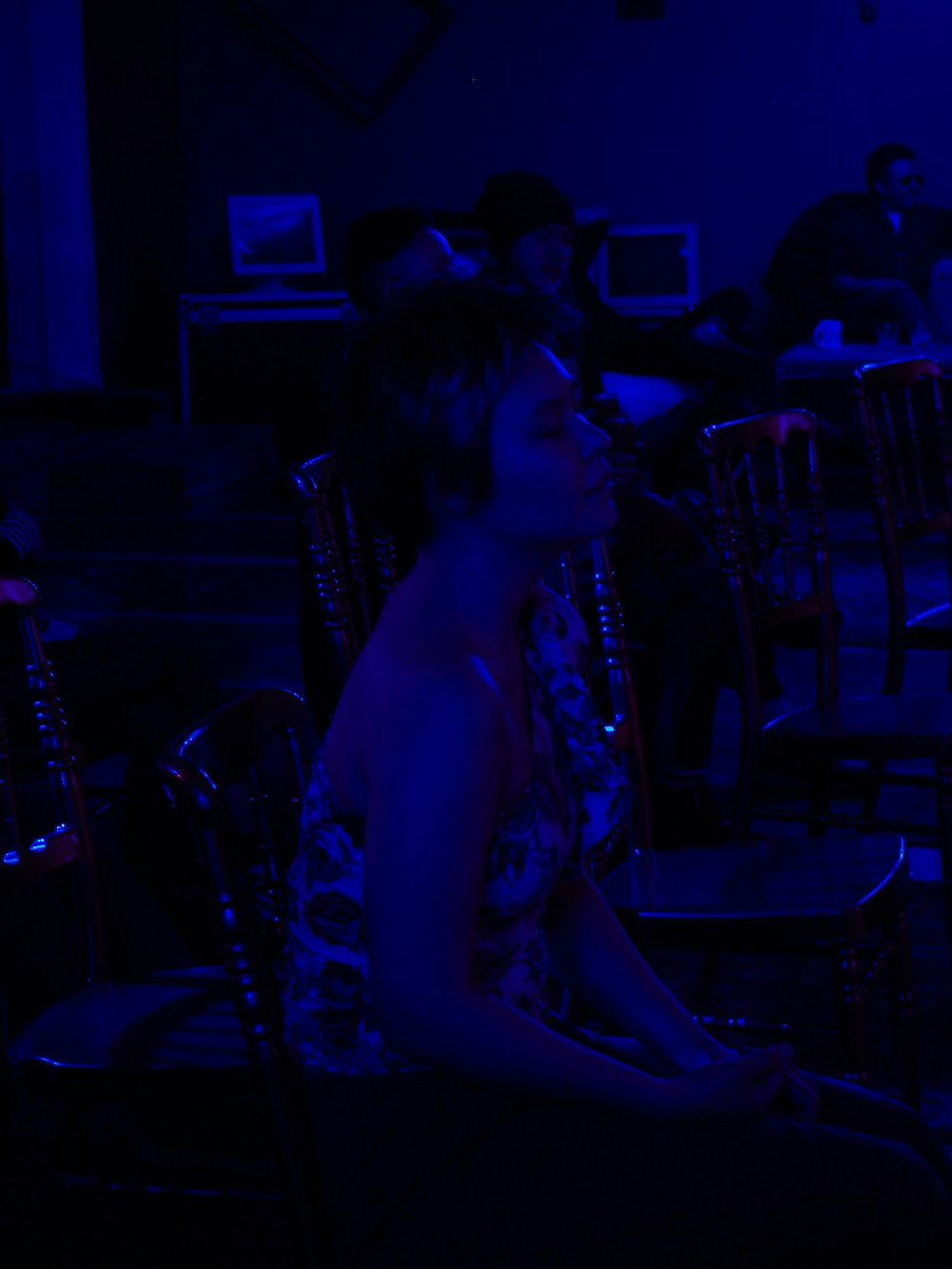 woman in blue dress sitting on chair