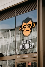 a monkey is reflected in the window of a restaurant
