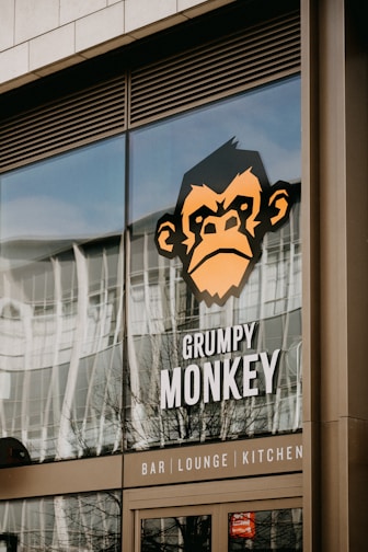 a monkey is reflected in the window of a restaurant