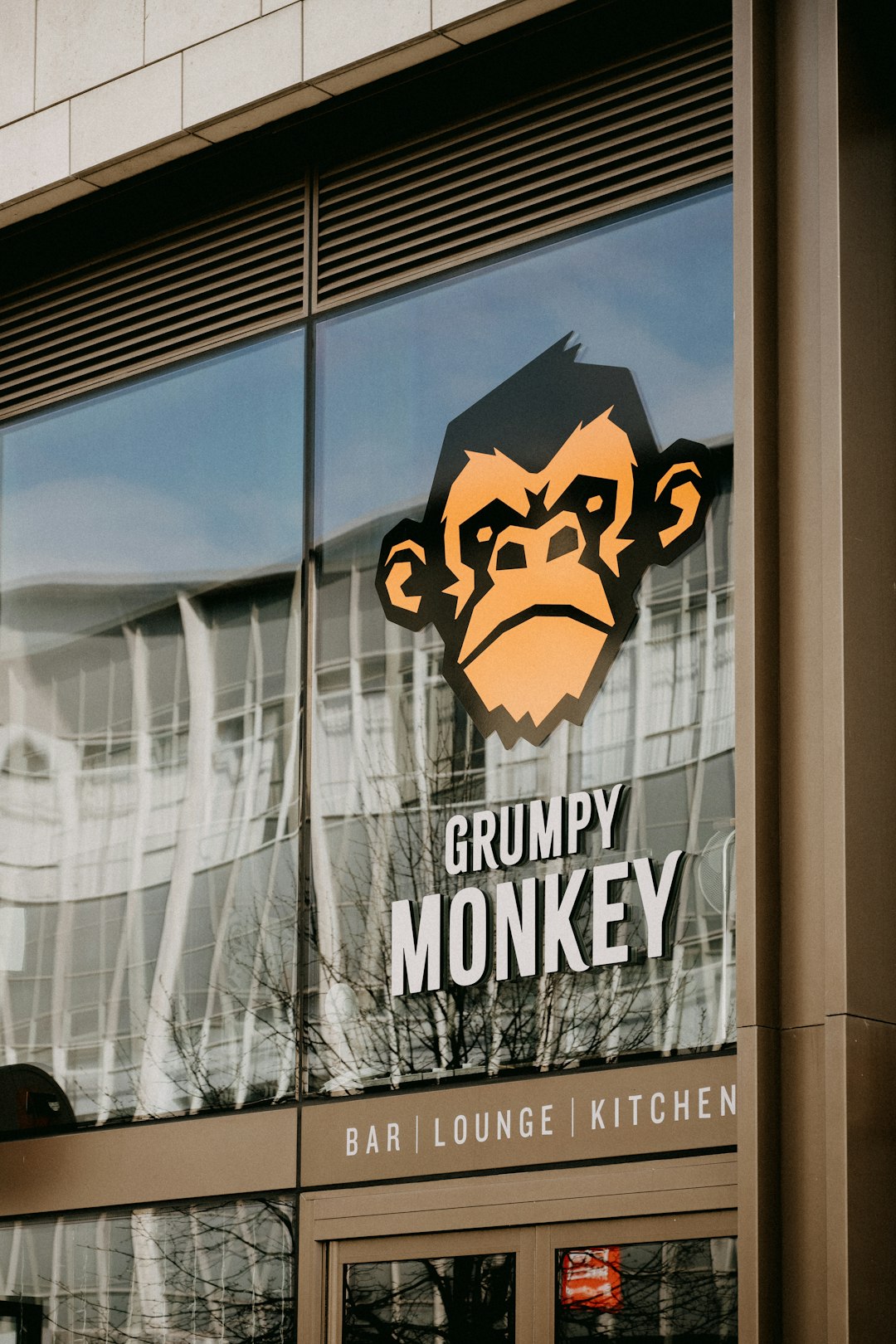 a monkey is reflected in the window of a restaurant
