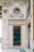 An ornate architectural facade featuring elegant designs and gold accents. A prominent circular window and a sign reading 'To the English Fashion' are focal points. Intricate detailing and embellishments are present, contributing to an elegant and vintage aesthetic.