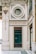 An ornate architectural facade featuring elegant designs and gold accents. A prominent circular window and a sign reading 'To the English Fashion' are focal points. Intricate detailing and embellishments are present, contributing to an elegant and vintage aesthetic.