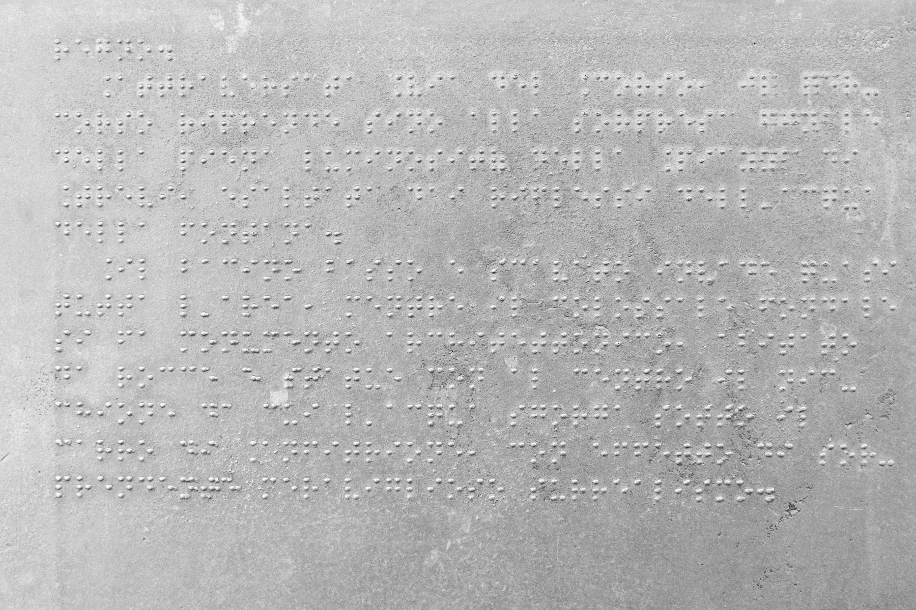 A gray surface covered edge to edge in lines of raised braille dots