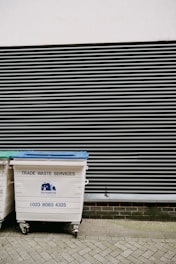 white and blue trash bin