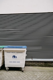 white and blue trash bin