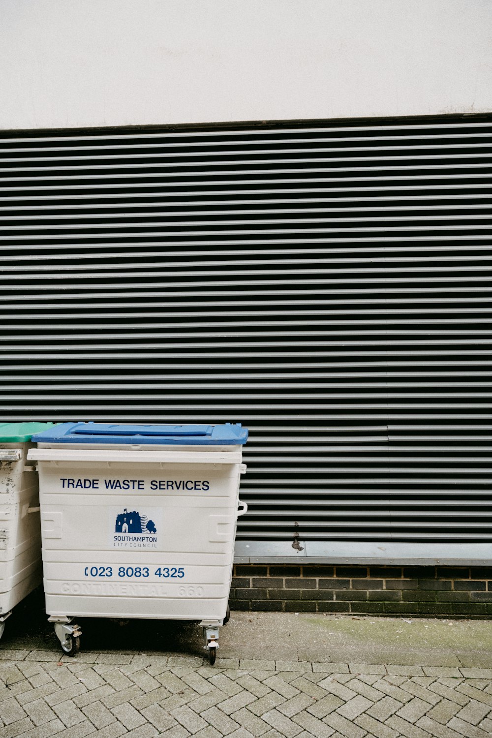 white and blue trash bin