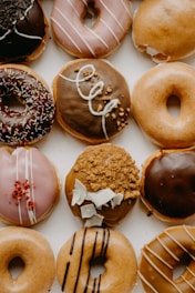 brown and white doughnuts on white ceramic plate