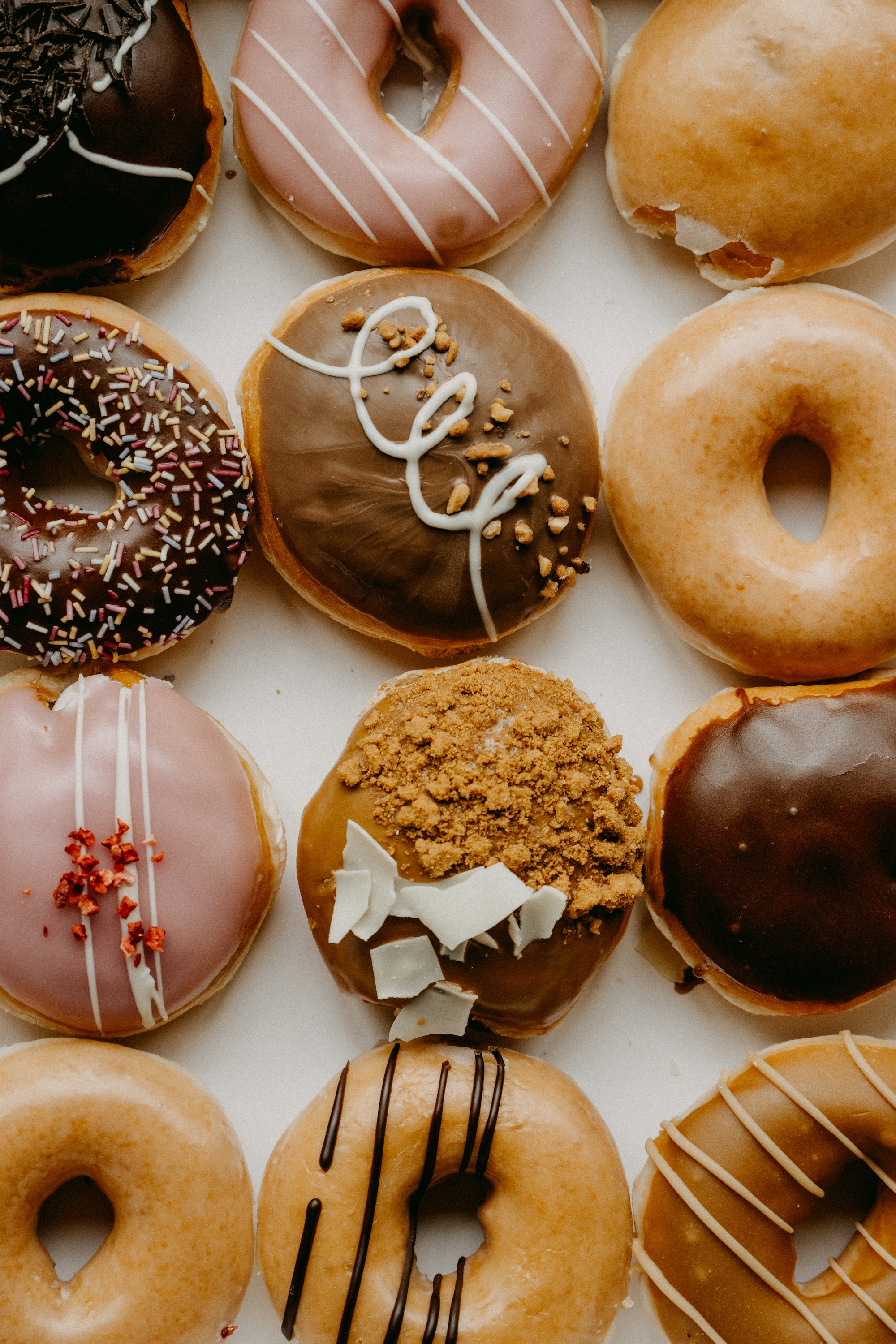 brown and white doughnuts on white ceramic plate