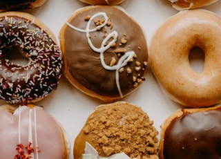 brown and white doughnuts on white ceramic plate