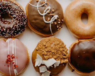 brown and white doughnuts on white ceramic plate