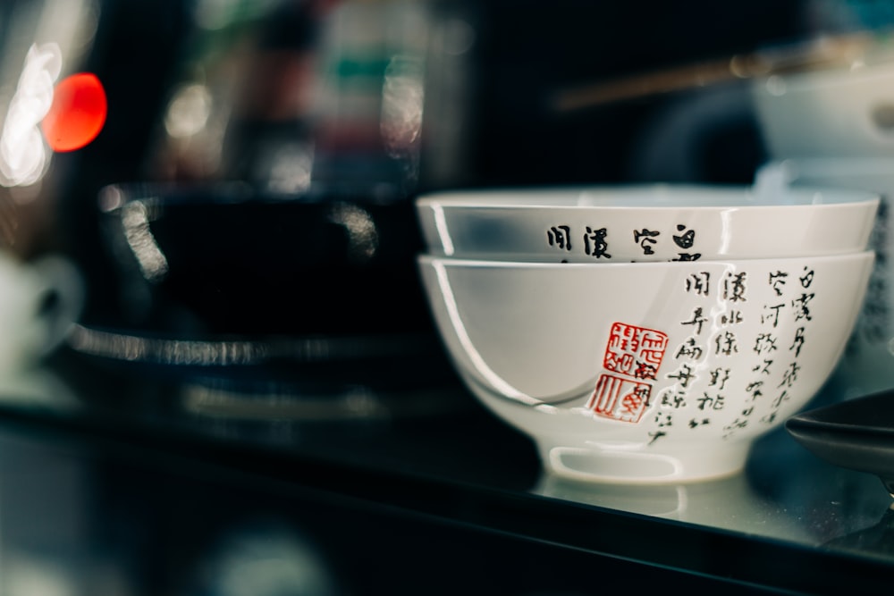 white ceramic bowl on black table