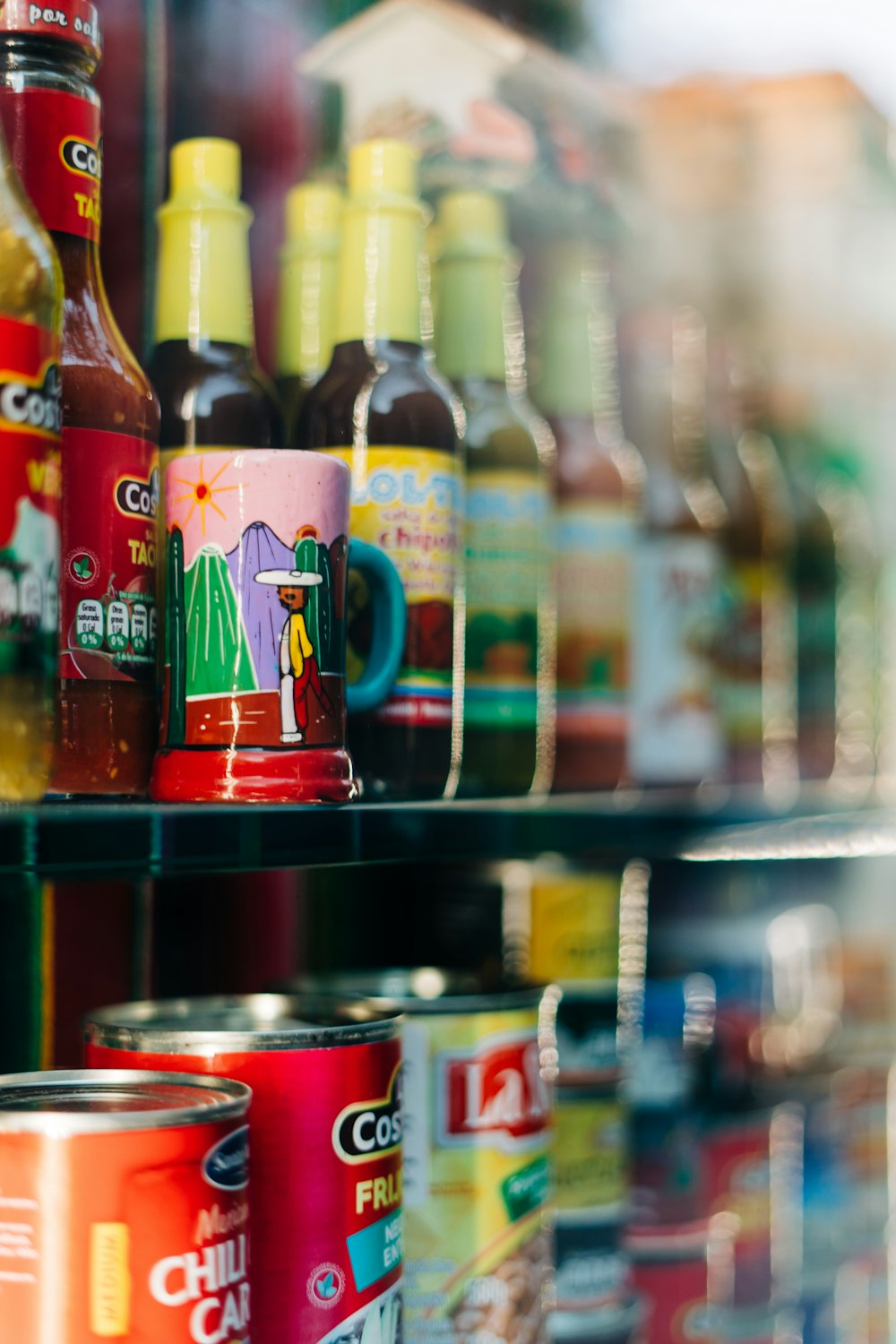 glass bottles on shelf with bottles