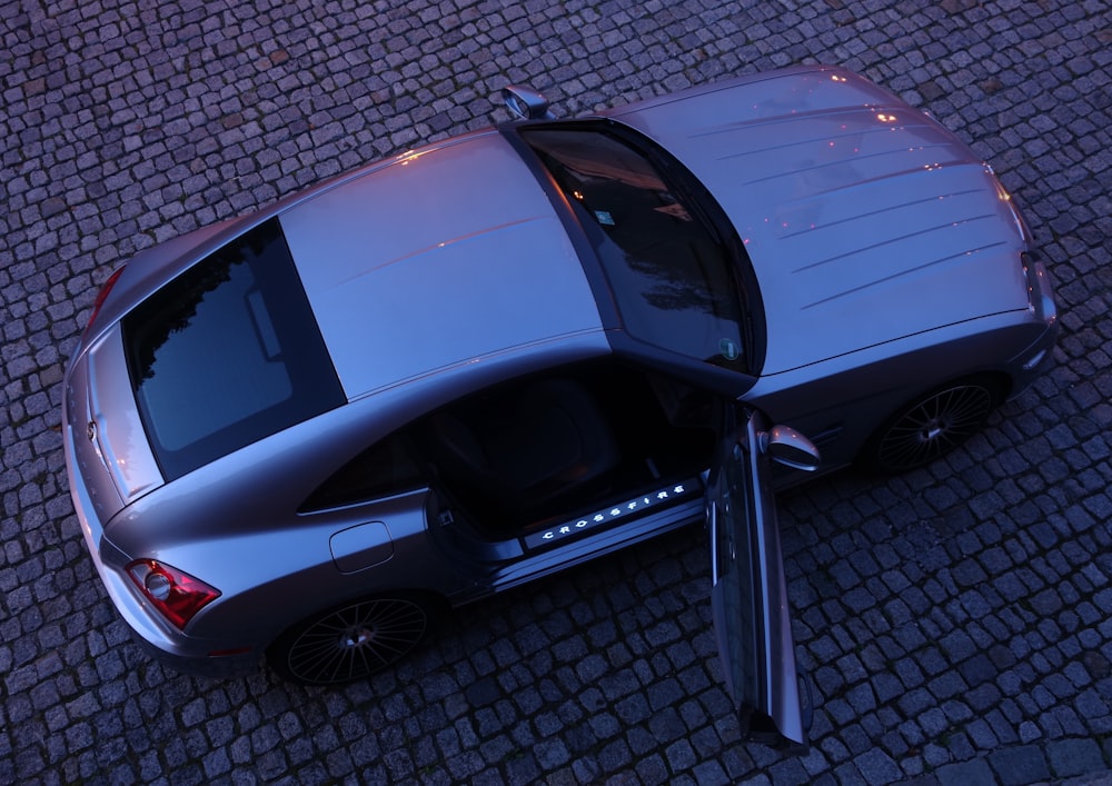 black car parked on gray pavement