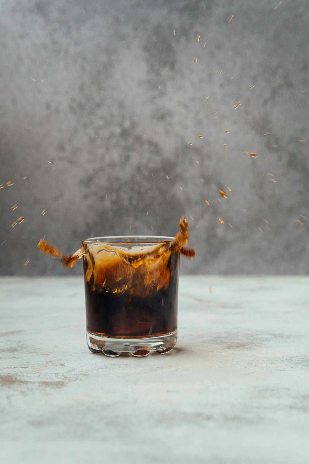 clear glass mug with brown liquid