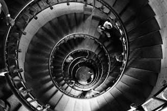 grayscale photo of spiral staircase