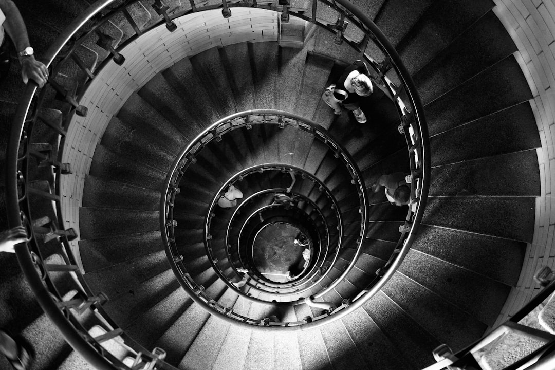 grayscale photo of spiral staircase