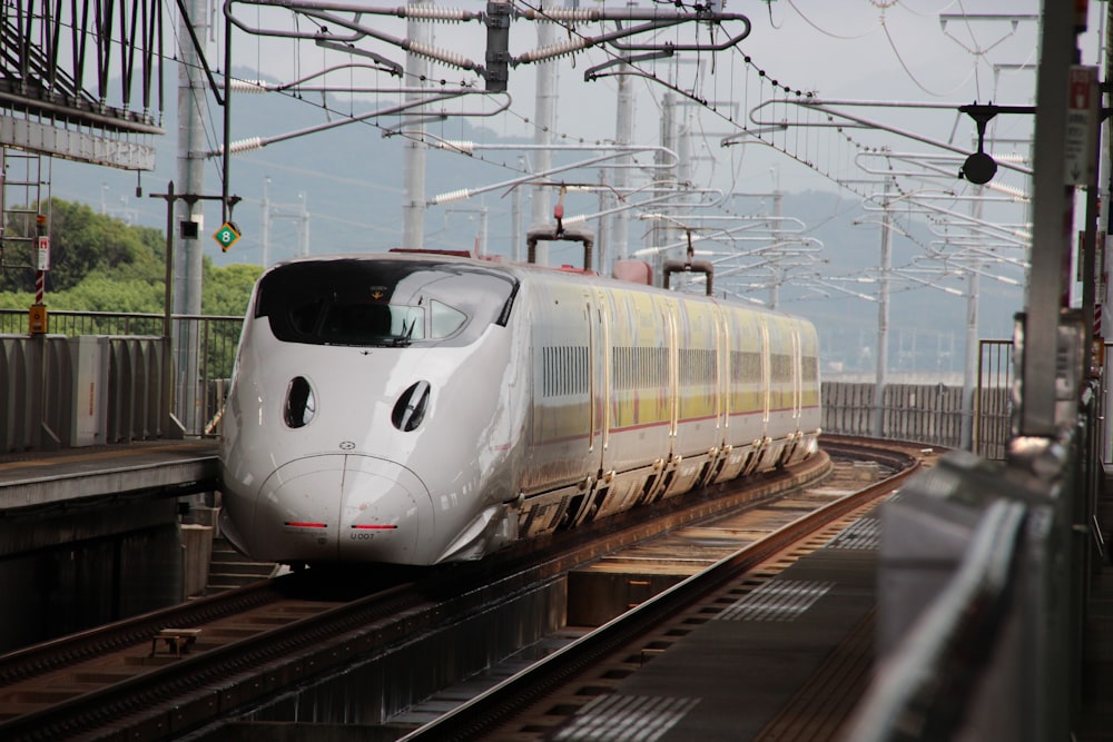 white train on rail tracks