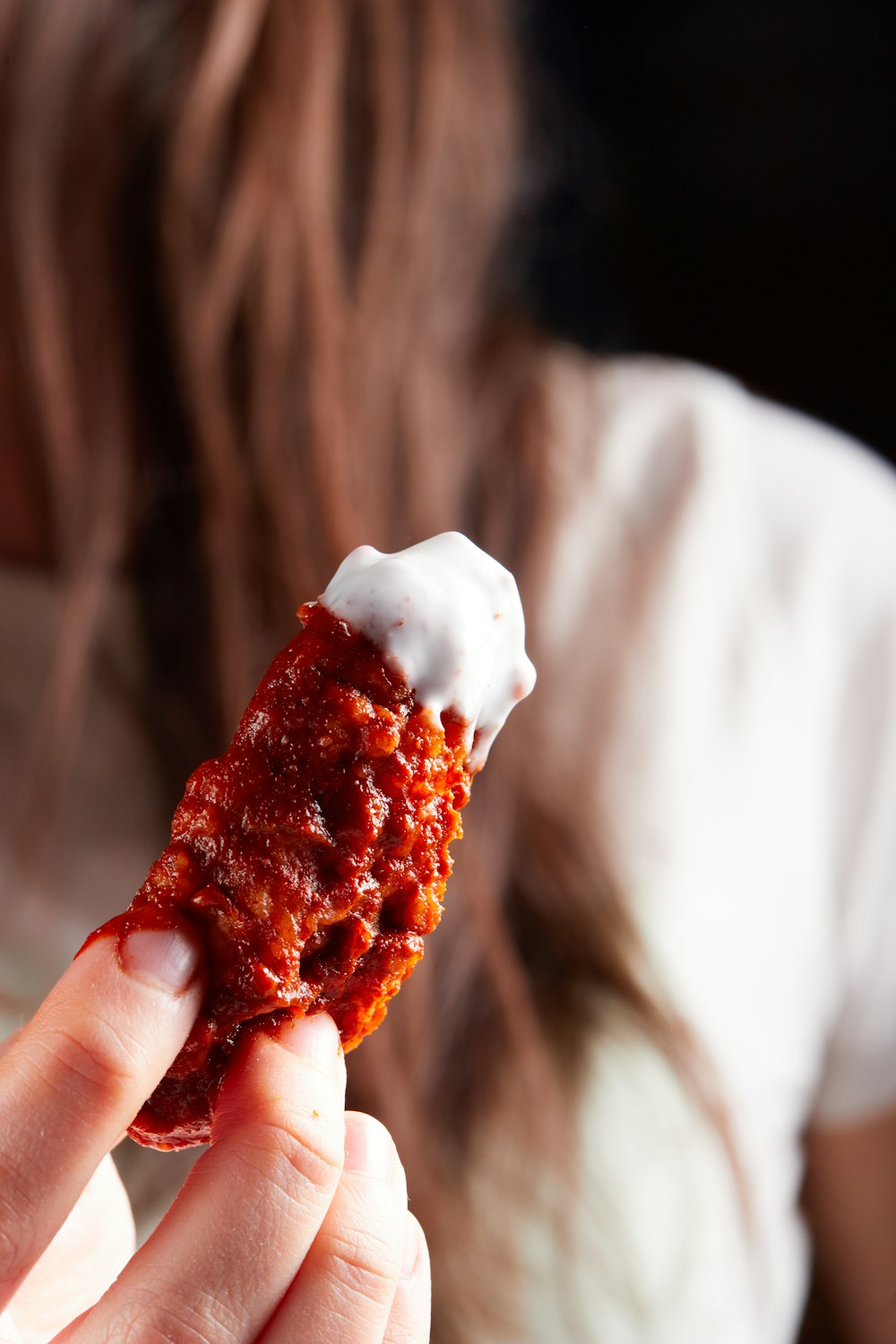 person holding brown and white ice cream