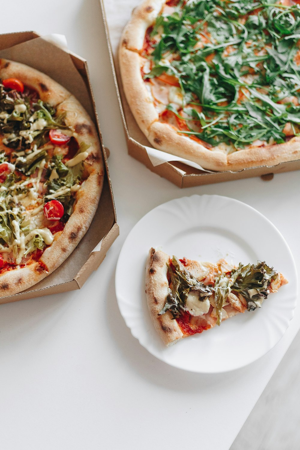 pizza with green leaf on white ceramic plate