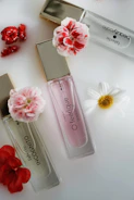 Elegant perfume bottles arranged on a wooden table with fresh flowers