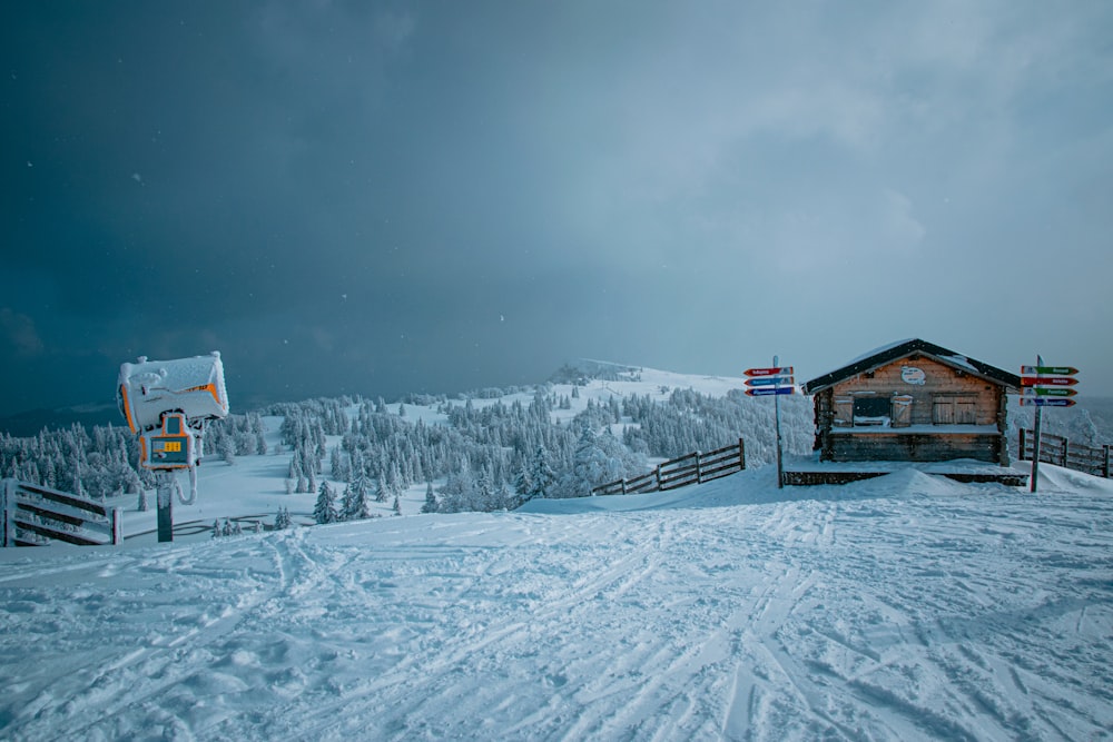 brown wooden house on snow covered ground during night time