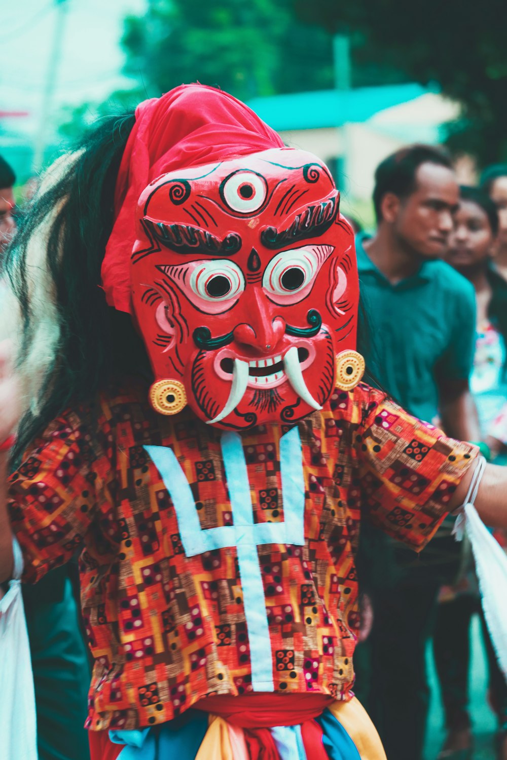 woman in red yellow and blue floral dress wearing white mask