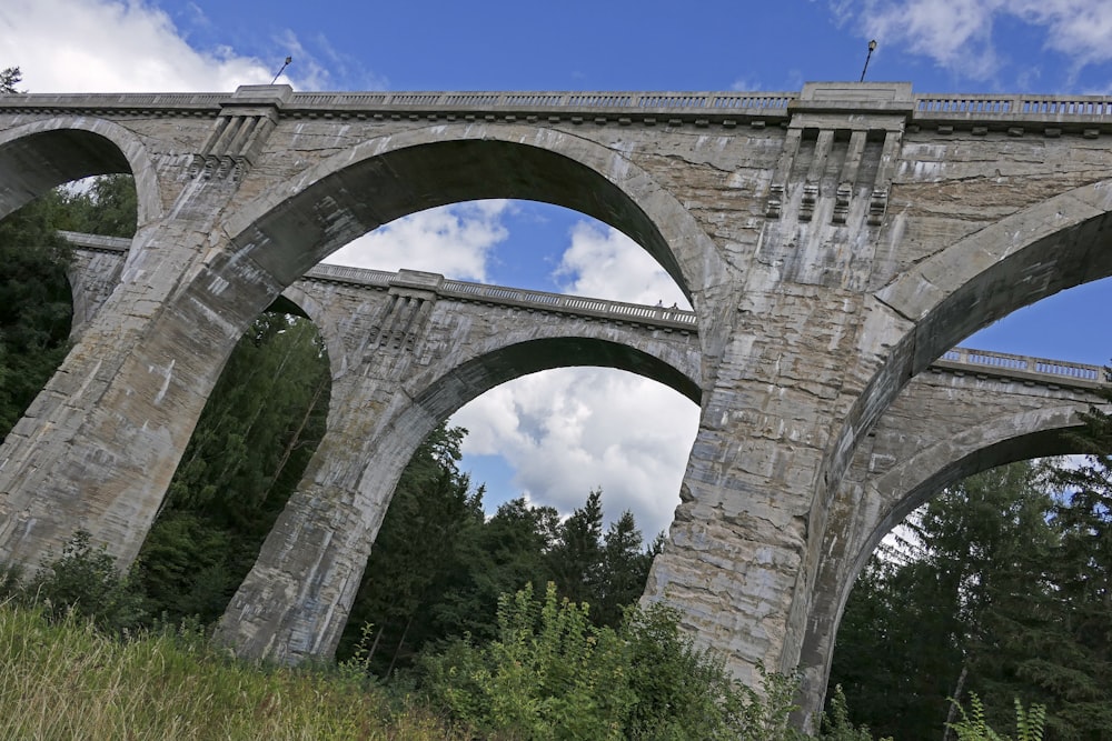 gray concrete bridge under white sky during daytime