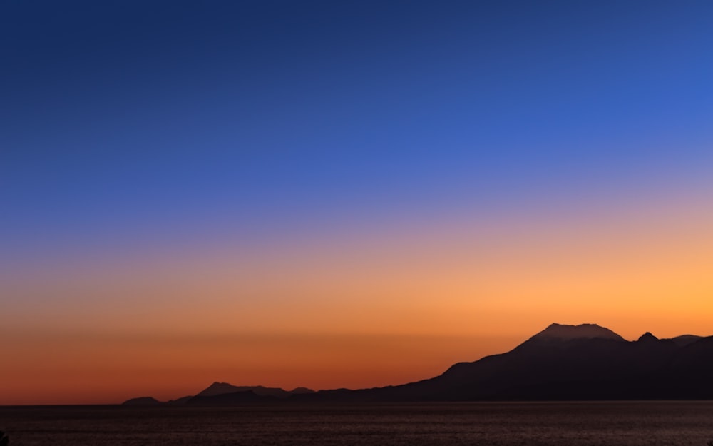 silhouette of mountain during sunset