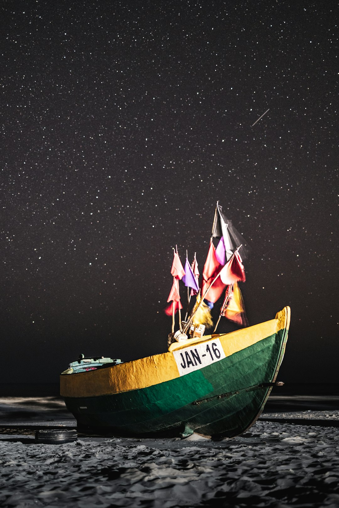 man and woman riding on green and brown boat under starry night