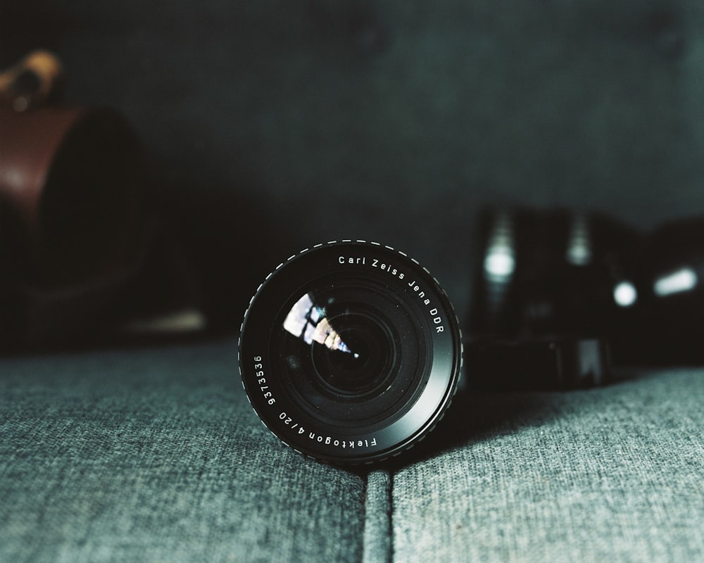 black camera lens on gray textile